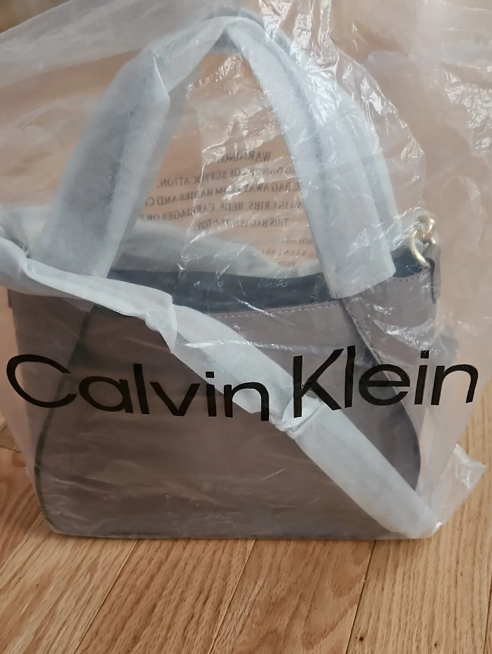 Calvin Klein small neutral tote with gold hardware. Includes a crossbody strap.